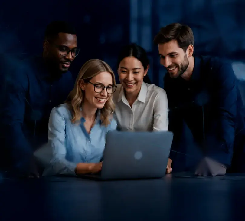 Four EdgeSphere colleagues working together around a laptop